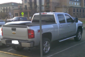 A pic of a silver, four-door, automatic pickup truck. Whited out license plate with "Paint" program